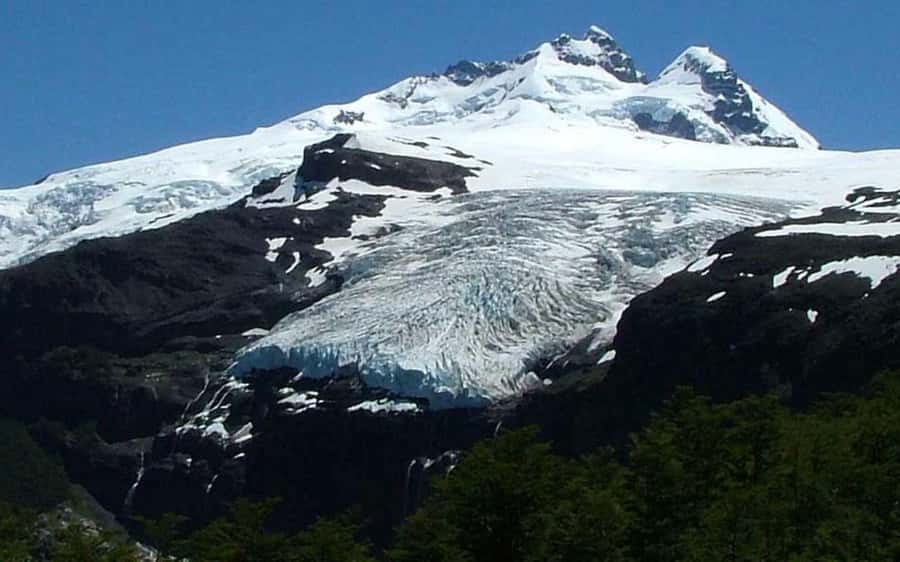 From Bariloche: Cerro Tronador Full-Day Tour - Reaching the base of a three-peak mountain