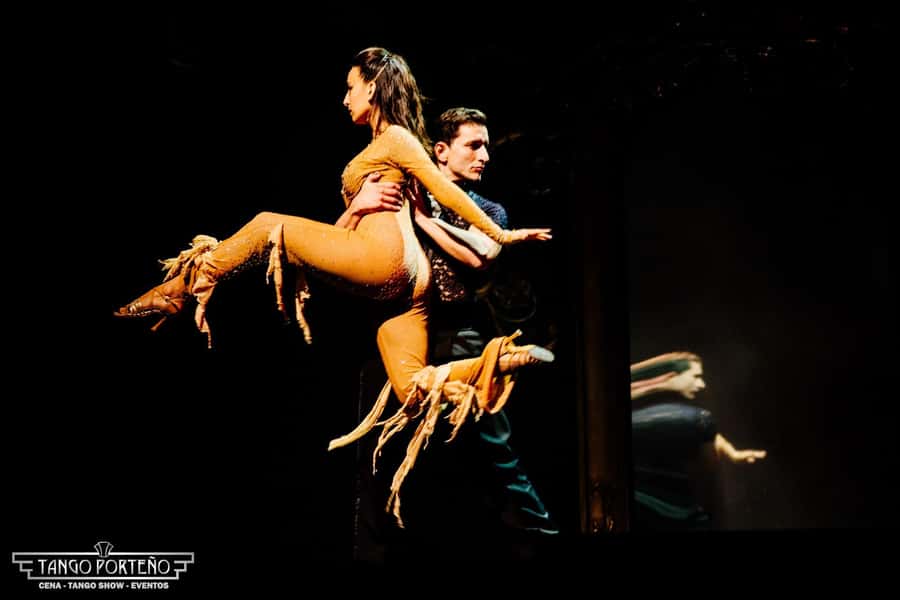 Two dancers mid-figure at a Buenos Aires tango show